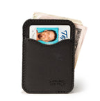 Slim Leather Card Wallet in Black with an ID card in the front pocket and folded cash behind