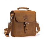 Indiana Leather Satchel in Tobacco, angled front view with buckled flap, top handle and shoulder strap