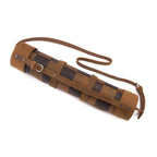 Leather Travel Chess Set in Tobacco, rolled checkerboard with buckled straps and shoulder strap, side view