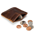 Bear Trap Leather Coin Purse in Dark Coffee Brown squeezed open to show coins inside, with coins beside it