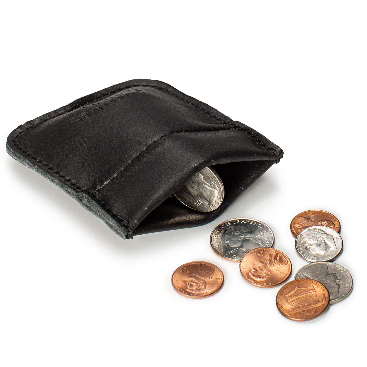 Bear Trap Leather Coin Purse in Black squeezed open to show coins inside, with coins beside it
