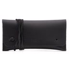 Cash & Receipt Bag in Black, closed flap with wrapped leather tie and embossed logo, front view