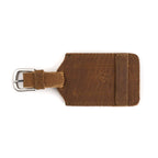 Leather Luggage Tag in Tobacco, back view with embossed tortoise and buckled strap