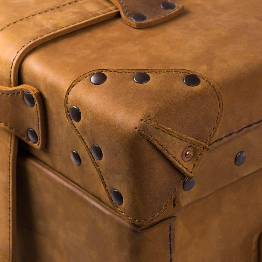 Leather Trunk in Tobacco, close-up of studded leather corner guard with copper rivet