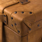 Leather Trunk in Tobacco, close-up of studded leather corner guard with copper rivet