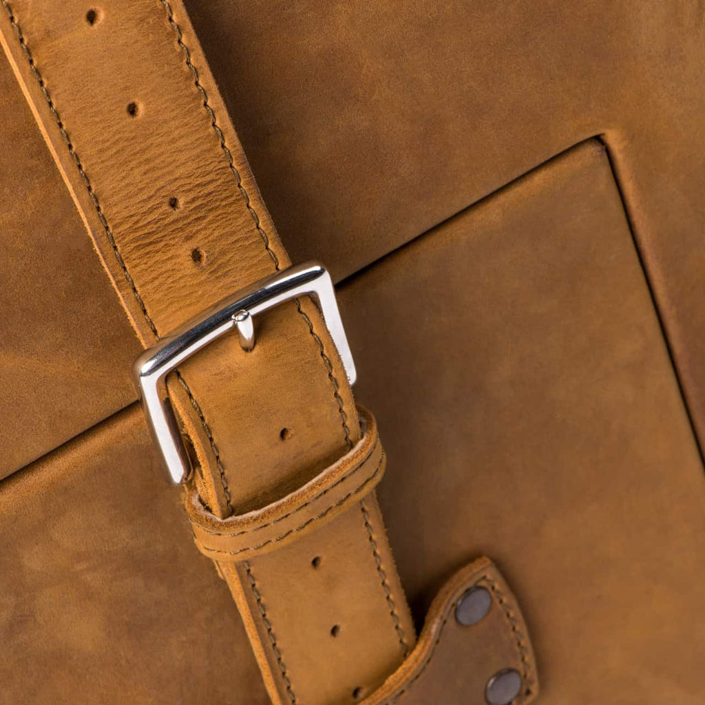 Leather Trunk in Tobacco, close-up of stitched strap with silver buckle and riveted anchor tab