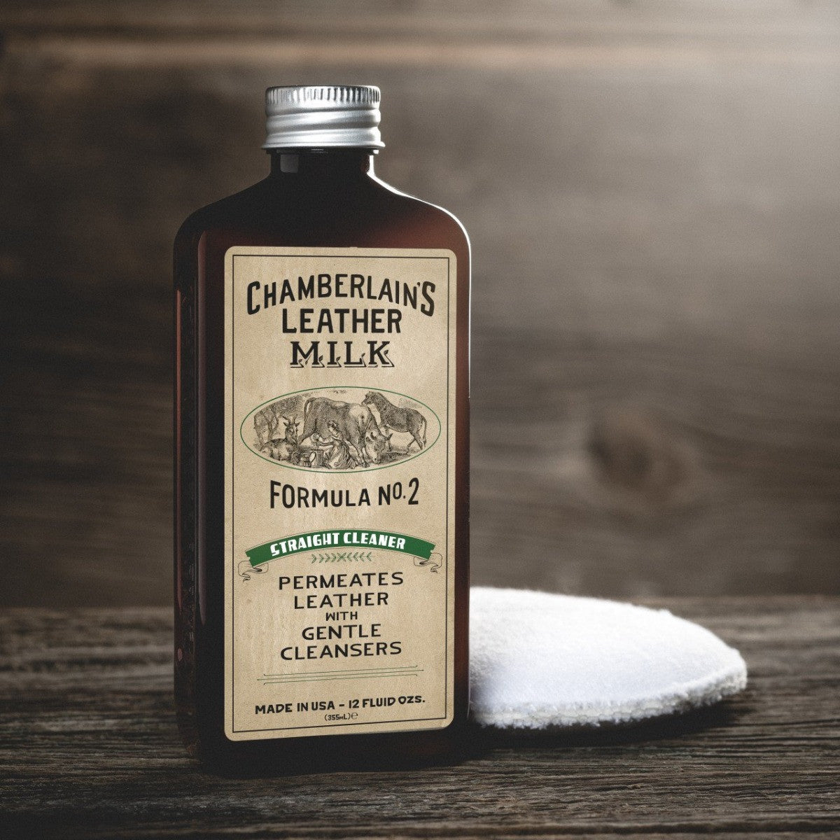 Chamberlain's No. 2 leather cleaner bottle beside an applicator pad on a wooden surface