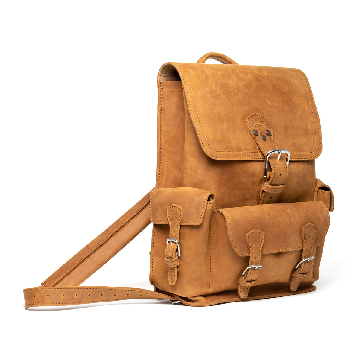 Thin Front Pocket Leather Backpack in Tobacco, angled view with buckled flap, front pocket and strap