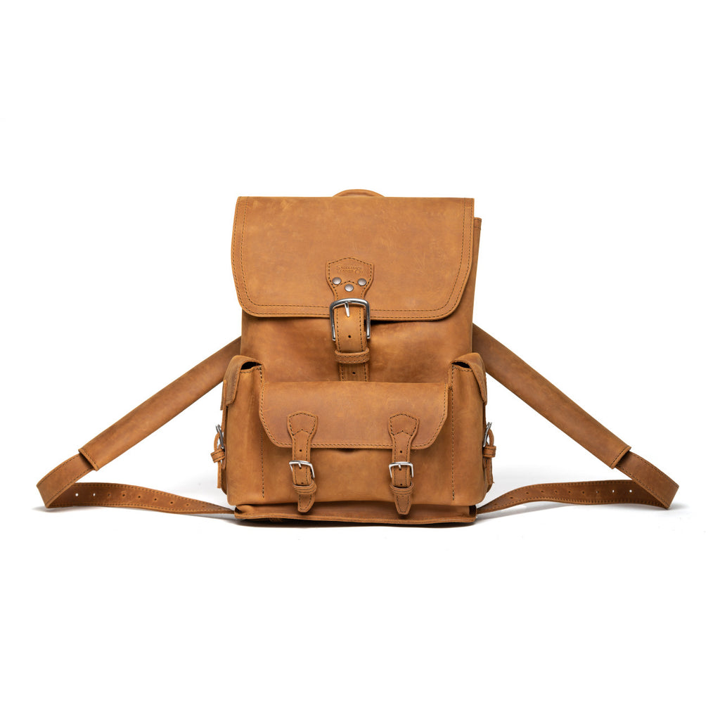Thin Front Pocket Leather Backpack in Tobacco, front view with buckled flap and front pocket