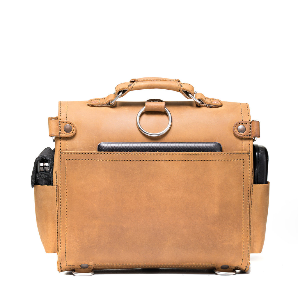Photographer's Satchel in Tobacco, back view with slip pocket, ring and filled side pockets