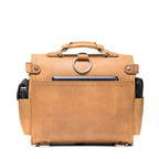 Photographer's Satchel in Tobacco, back view with slip pocket, ring and filled side pockets