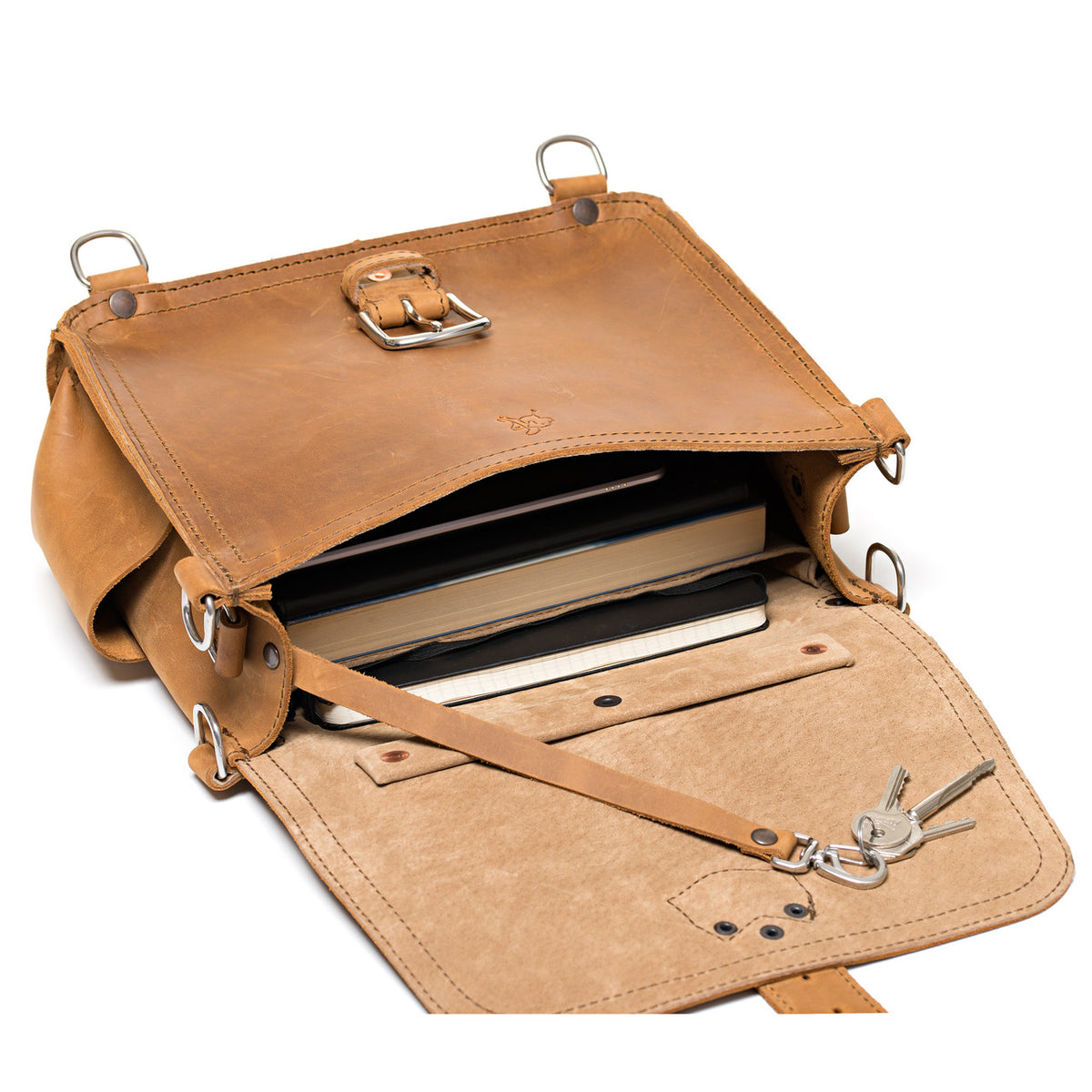 Photographer's Satchel in Tobacco, open flap showing books inside and a key leash with keys