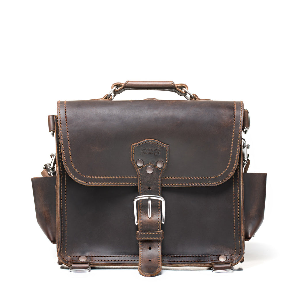 Photographer's Satchel in Dark Coffee Brown, front view with buckled flap, top handle and side pockets