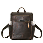 All in One Leather Backpack in Dark Coffee Brown, front view with a phone in front pocket and items in side pockets