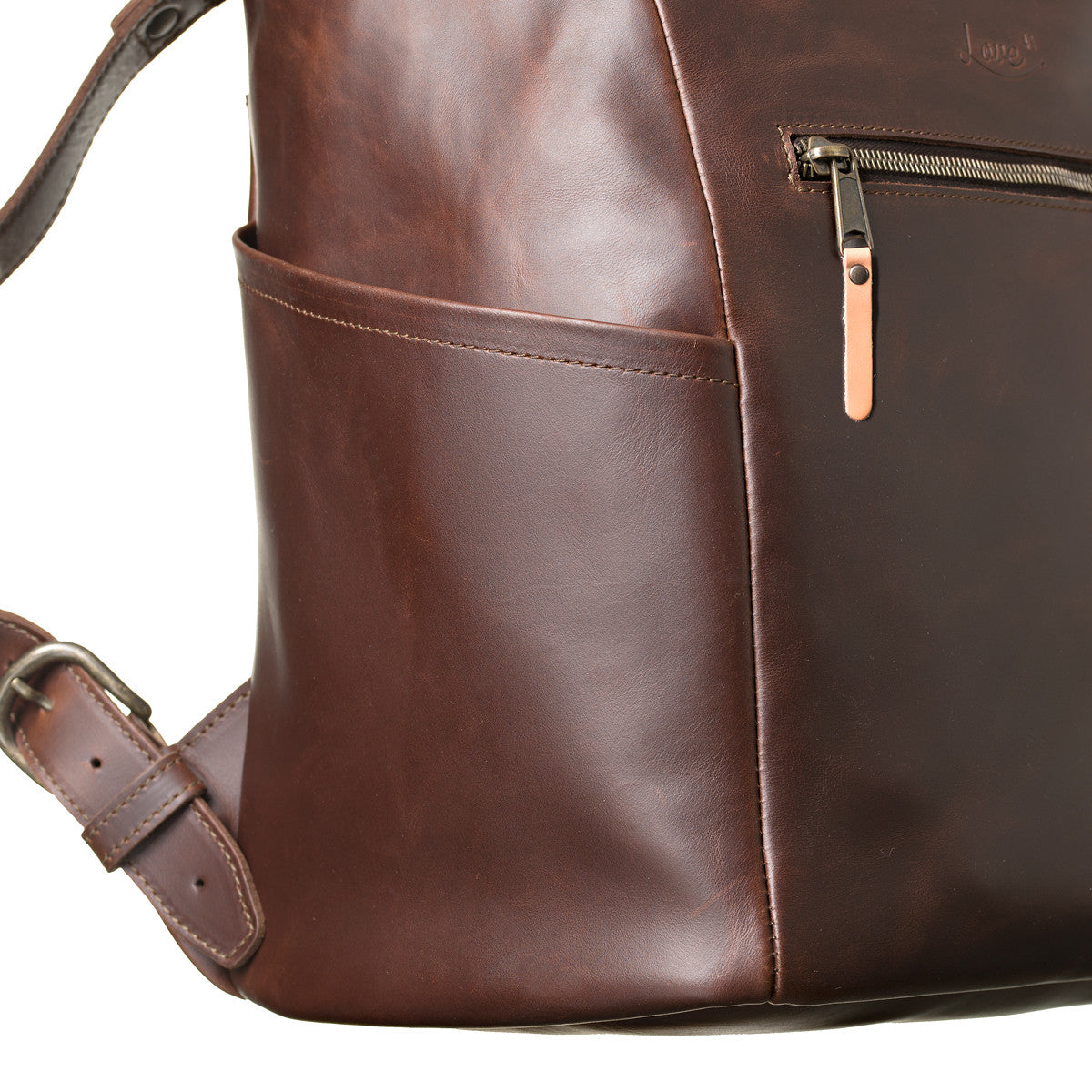 All in One Leather Backpack in Chestnut, close-up of side pocket, zipper pull and strap buckle
