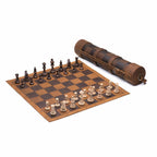Leather Travel Chess Set in Tobacco, leather board set up with wooden chess pieces beside its rolled carrying case