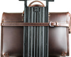 Leather Luggage Strap in Chestnut buckled around a briefcase to secure it to a rolling suitcase handle
