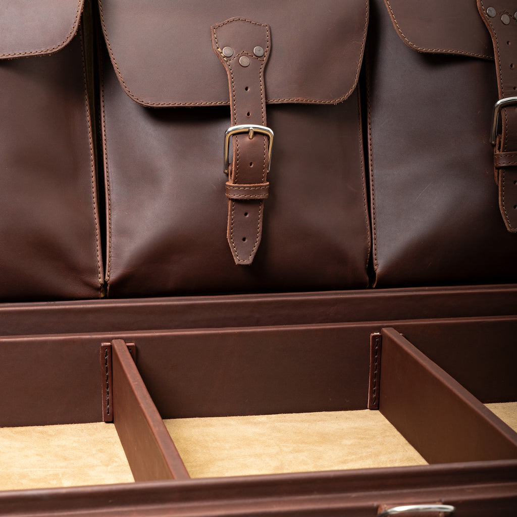 Leather Trunk in Chestnut, close-up of buckled lid pockets above the divided top tray