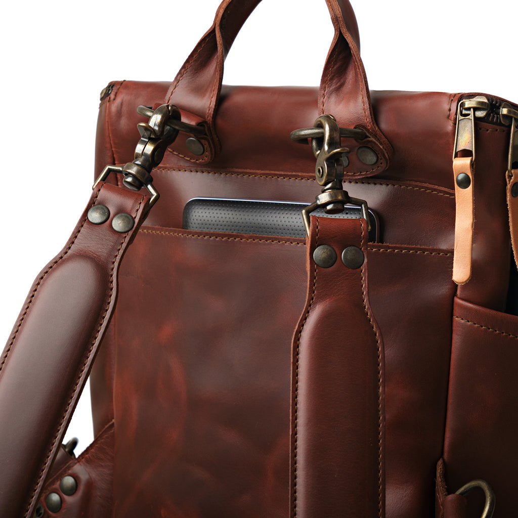 All in One Backpack Medium in Chestnut, close-up of back panel with swivel clips, rivets and laptop sleeve
