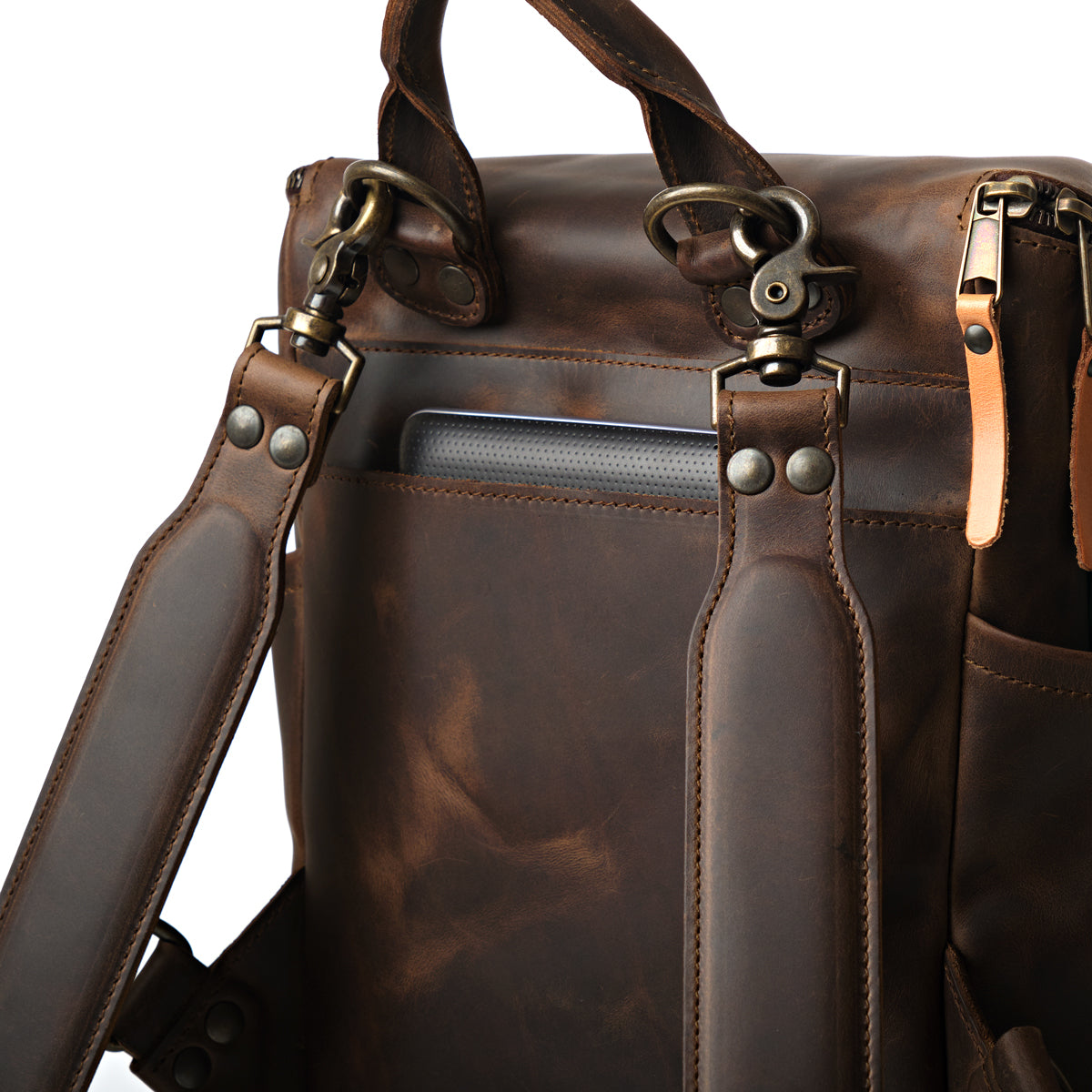 All in One Backpack Medium in Dark Coffee Brown, close-up of back panel with swivel clips, rivets and laptop sleeve