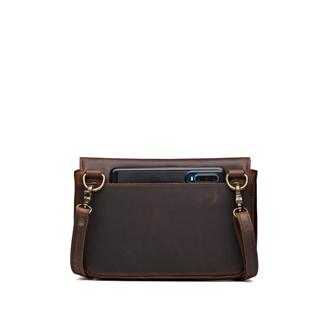 Magnetic Fold Over Bag Medium in Dark Coffee Brown, back view with a phone in the rear slip pocket
