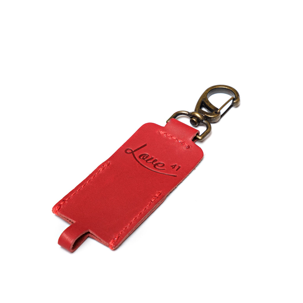 Leather Chapstick Holder in red, empty front view with embossed Love 41 logo and brass clasp