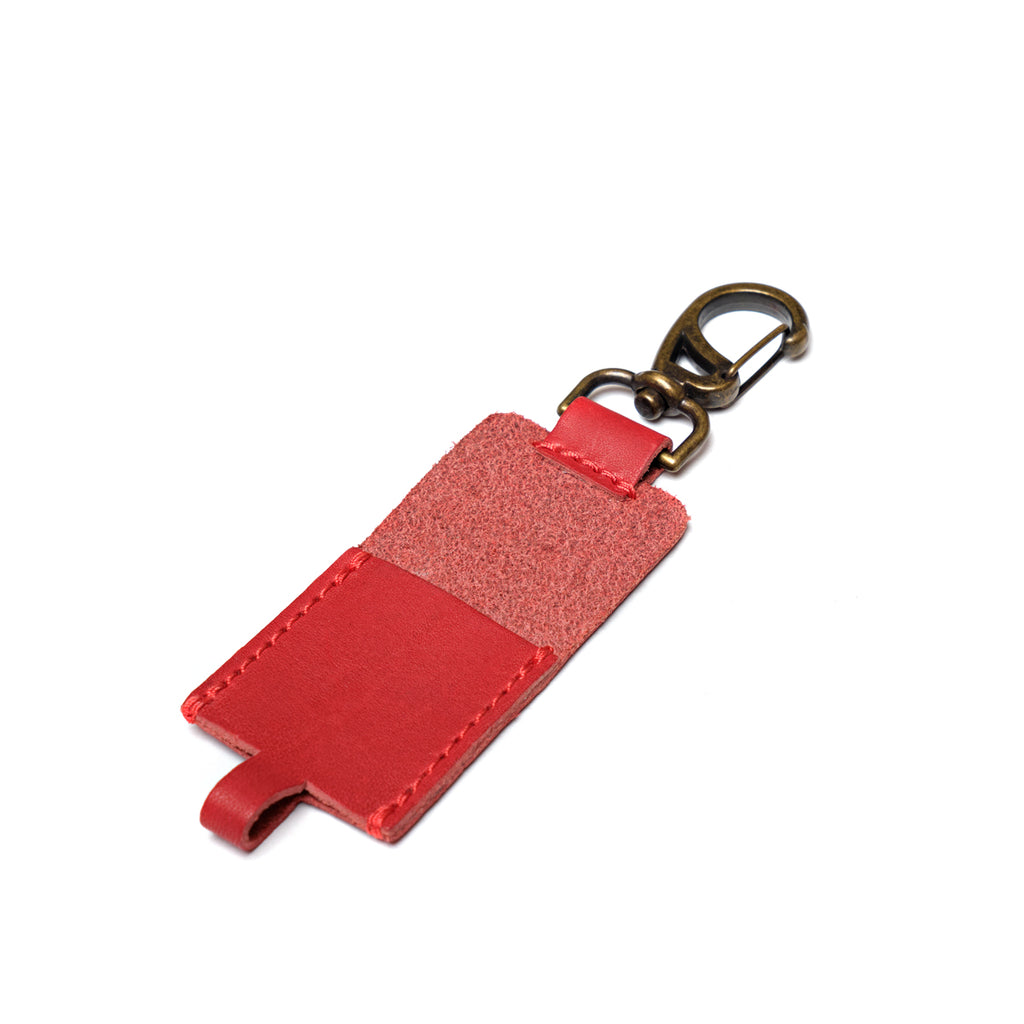 Leather Chapstick Holder in red, empty back view showing suede side and brass swivel clasp