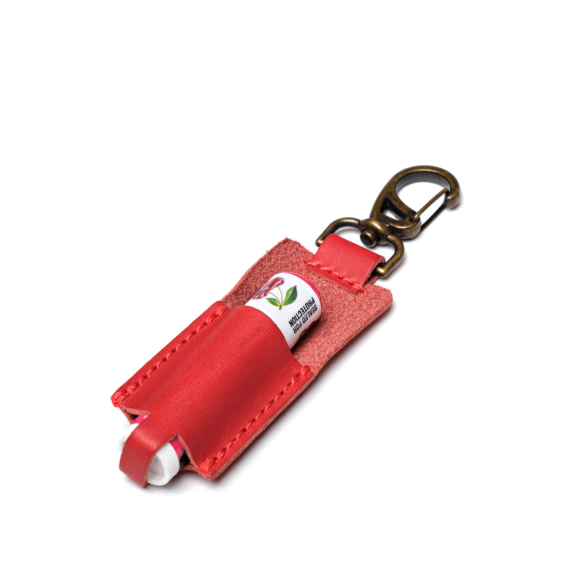Leather Chapstick Holder in red, holding a lip balm with brass swivel clasp keychain