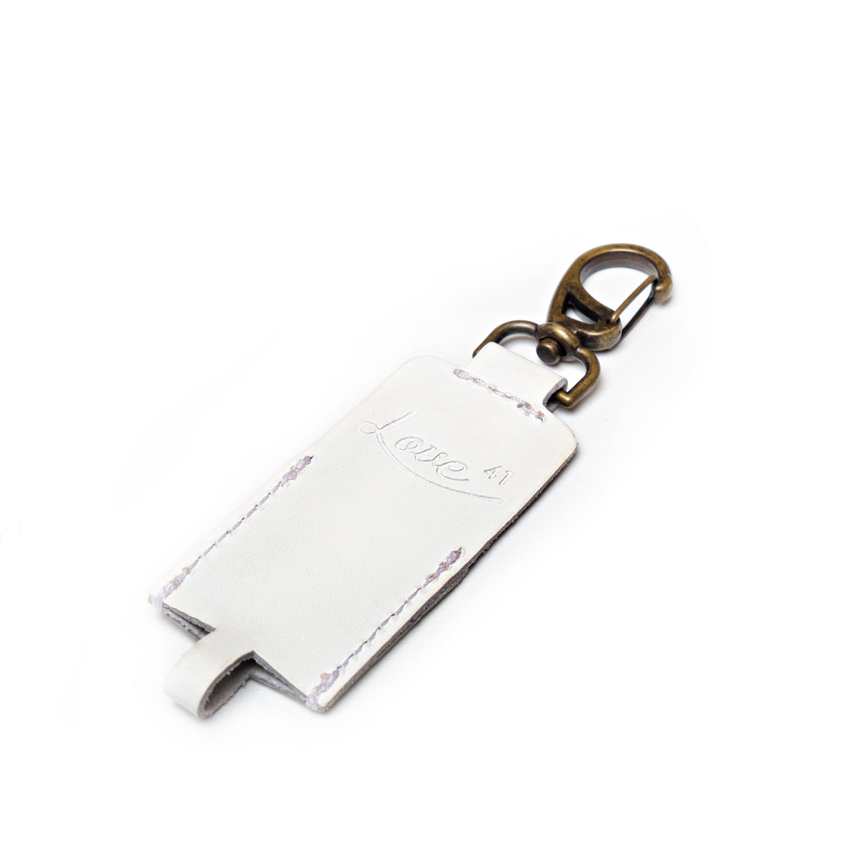 Leather Chapstick Holder in white, empty front view with embossed Love 41 logo and brass clasp