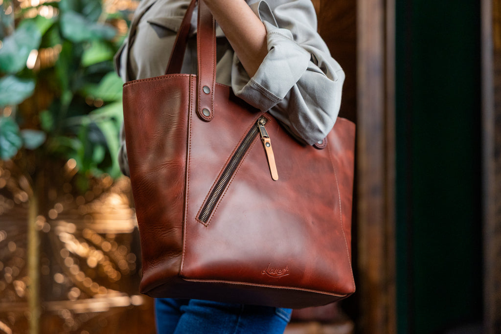 Concealed Carry Leather Tote in Chestnut, carried on the shoulder showing the diagonal zippered pocket