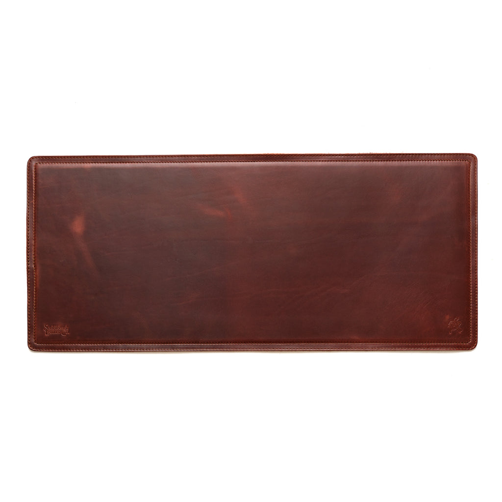 Long Desk Pad in Chestnut, empty top-down view showing stitched border and rounded corners