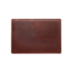 Desk Pad in Chestnut leather, empty top-down view showing stitched border and rounded corners