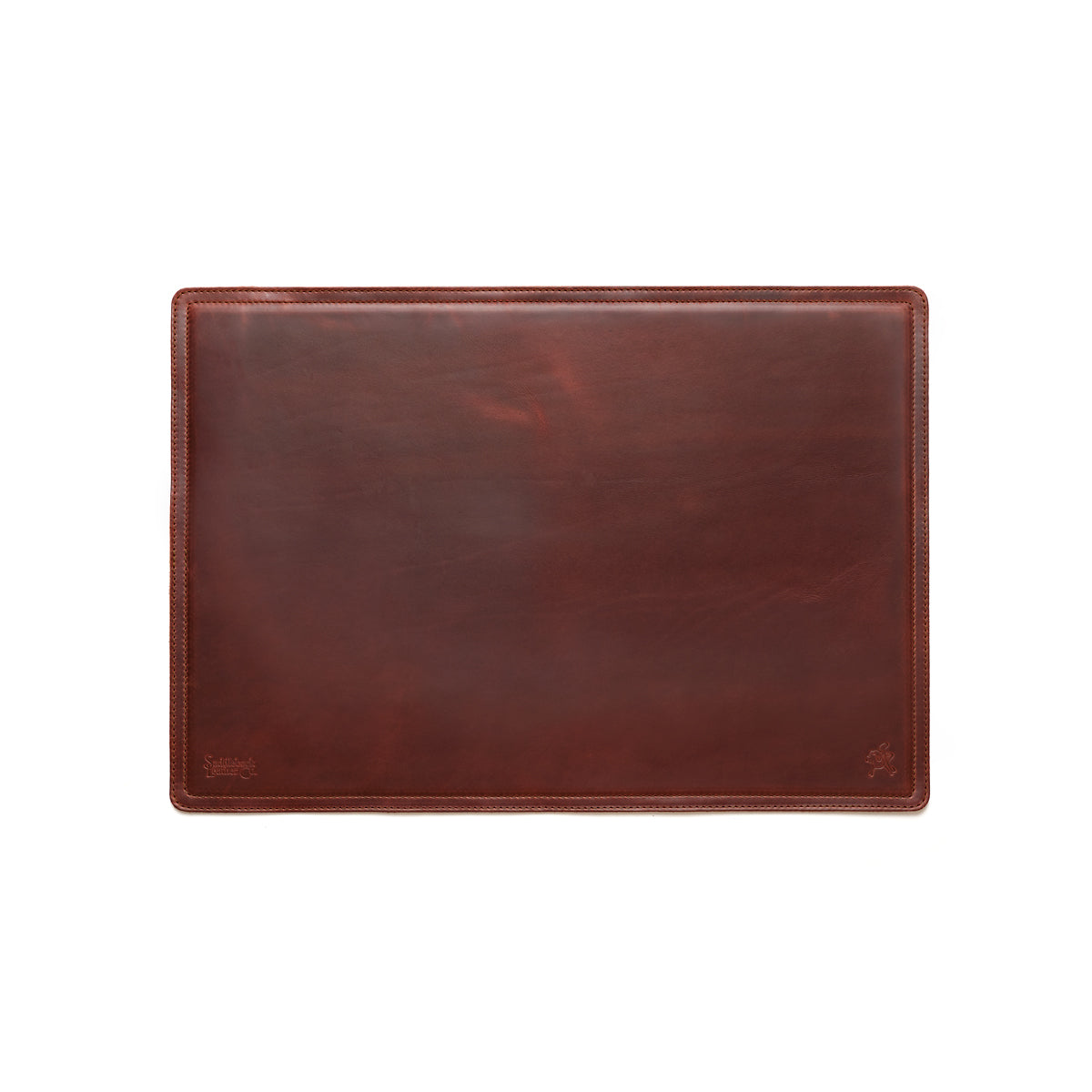 Desk Pad in Chestnut leather, empty top-down view showing stitched border and rounded corners