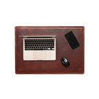 Desk Pad in Chestnut styled as a workspace with a laptop, phone and mouse, overhead view