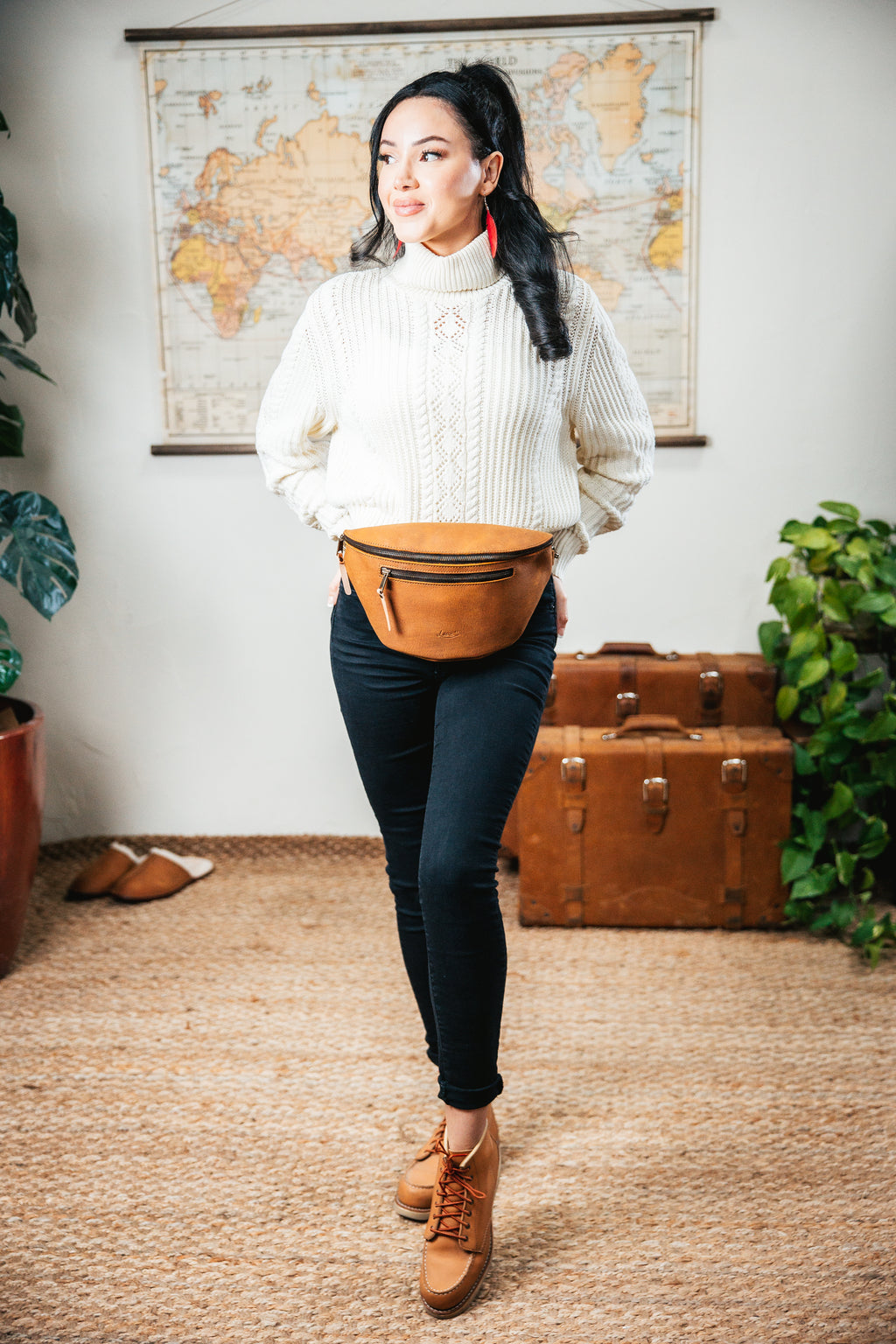 Leather Tumbled Fanny Bag in Tobacco, worn at the waist by a woman in a white cable-knit sweater