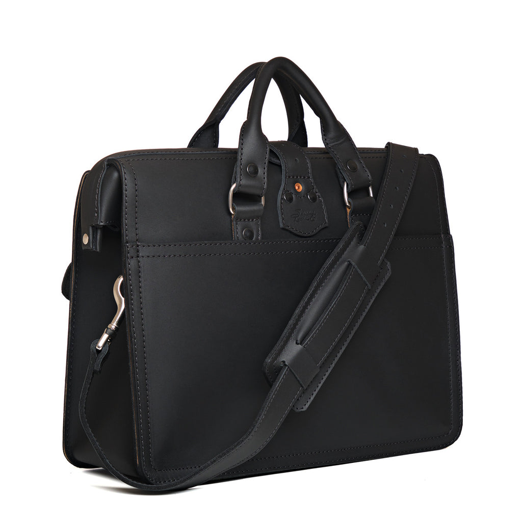 Flight Bag Leather Briefcase in black, angled back view with slip pocket and padded shoulder strap