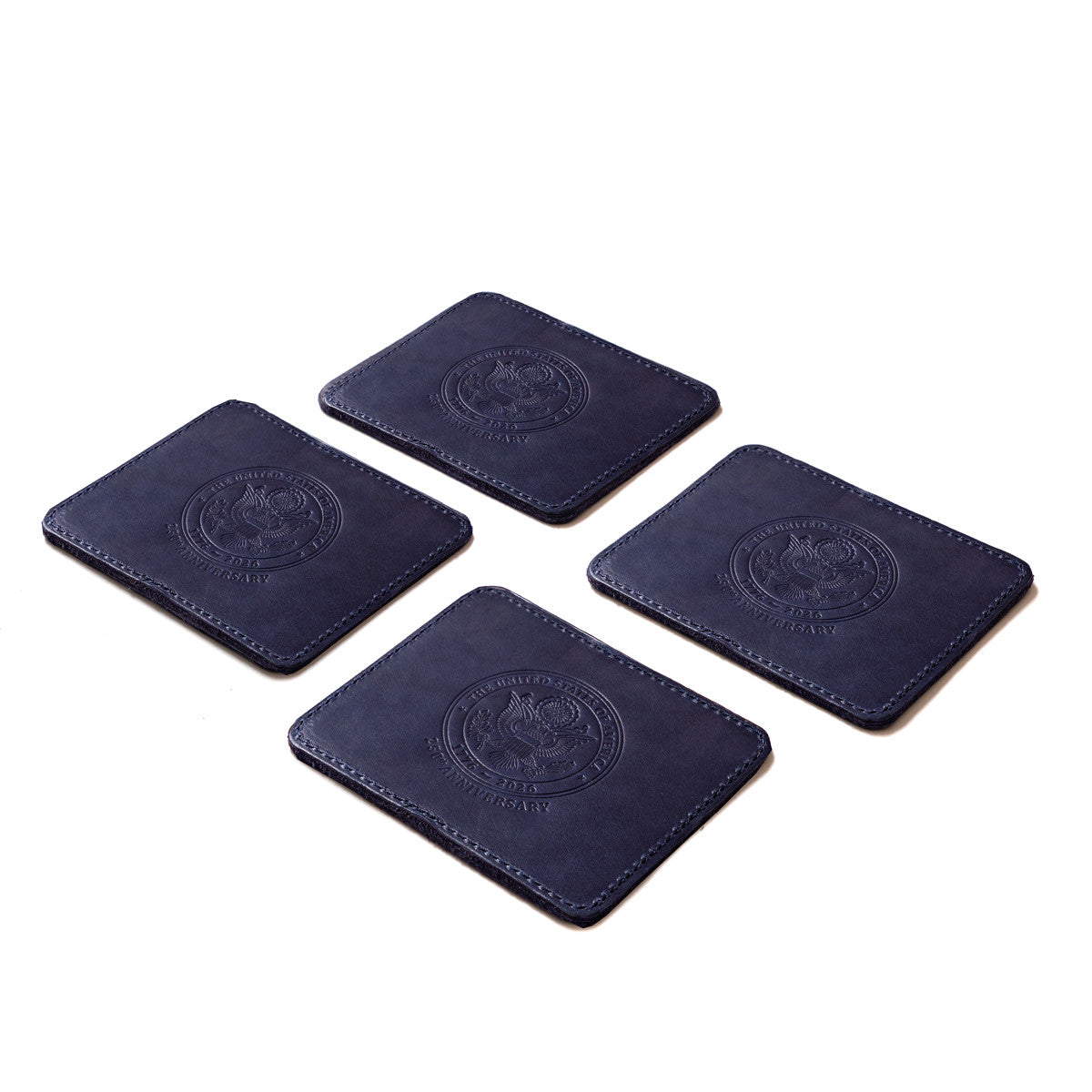 Saddleback Club Membership John Adams Leather Coaster Set in Blue and Red, four navy coasters with embossed seal laid out