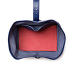 Saddleback Club Membership George Washington Leather Roll-Up Toiletry Bag in Blue, top-down view of red lined interior