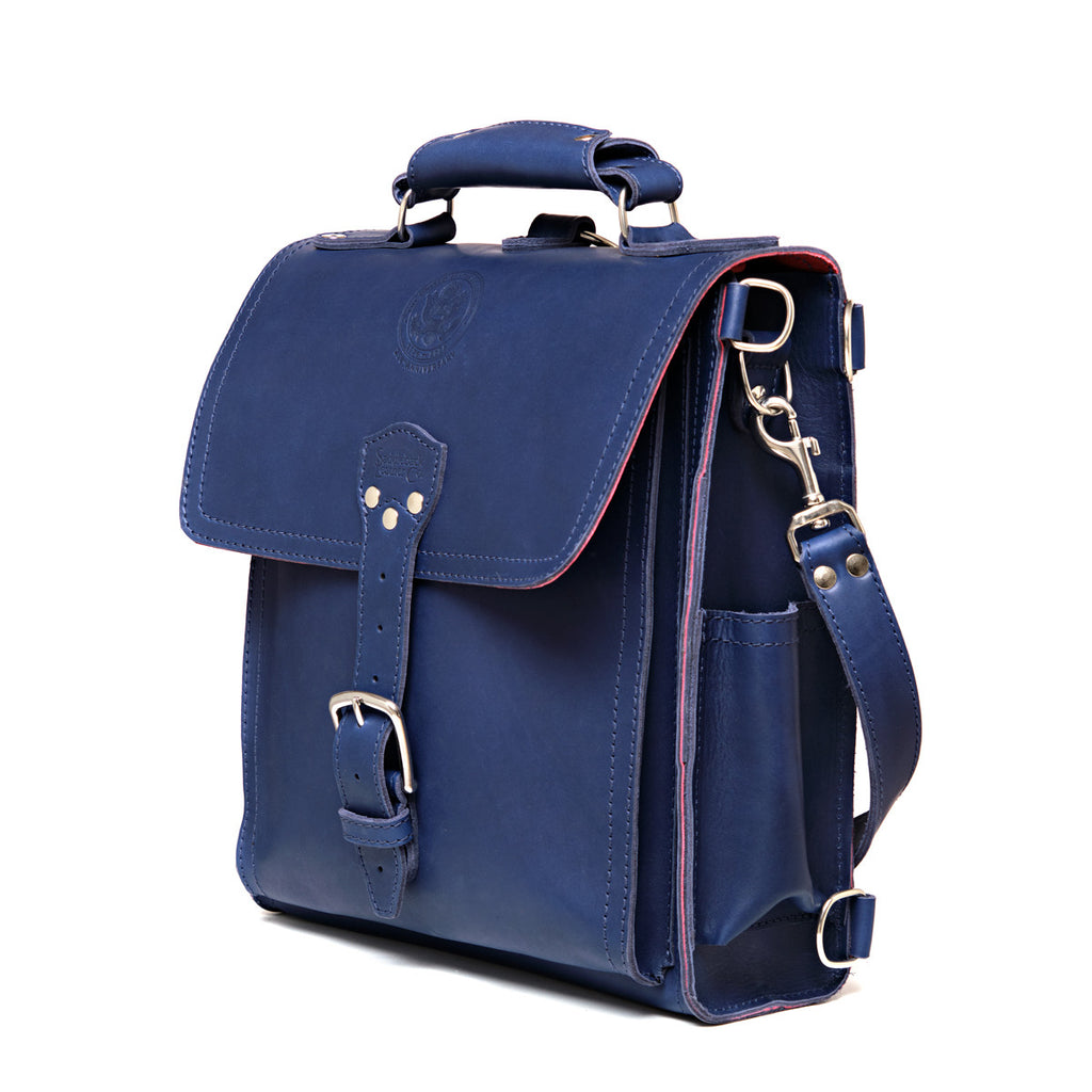 Saddleback Club Membership Paul Revere Leather Messenger Bag Backpack in Red, White and Blue, angled front view with buckle flap