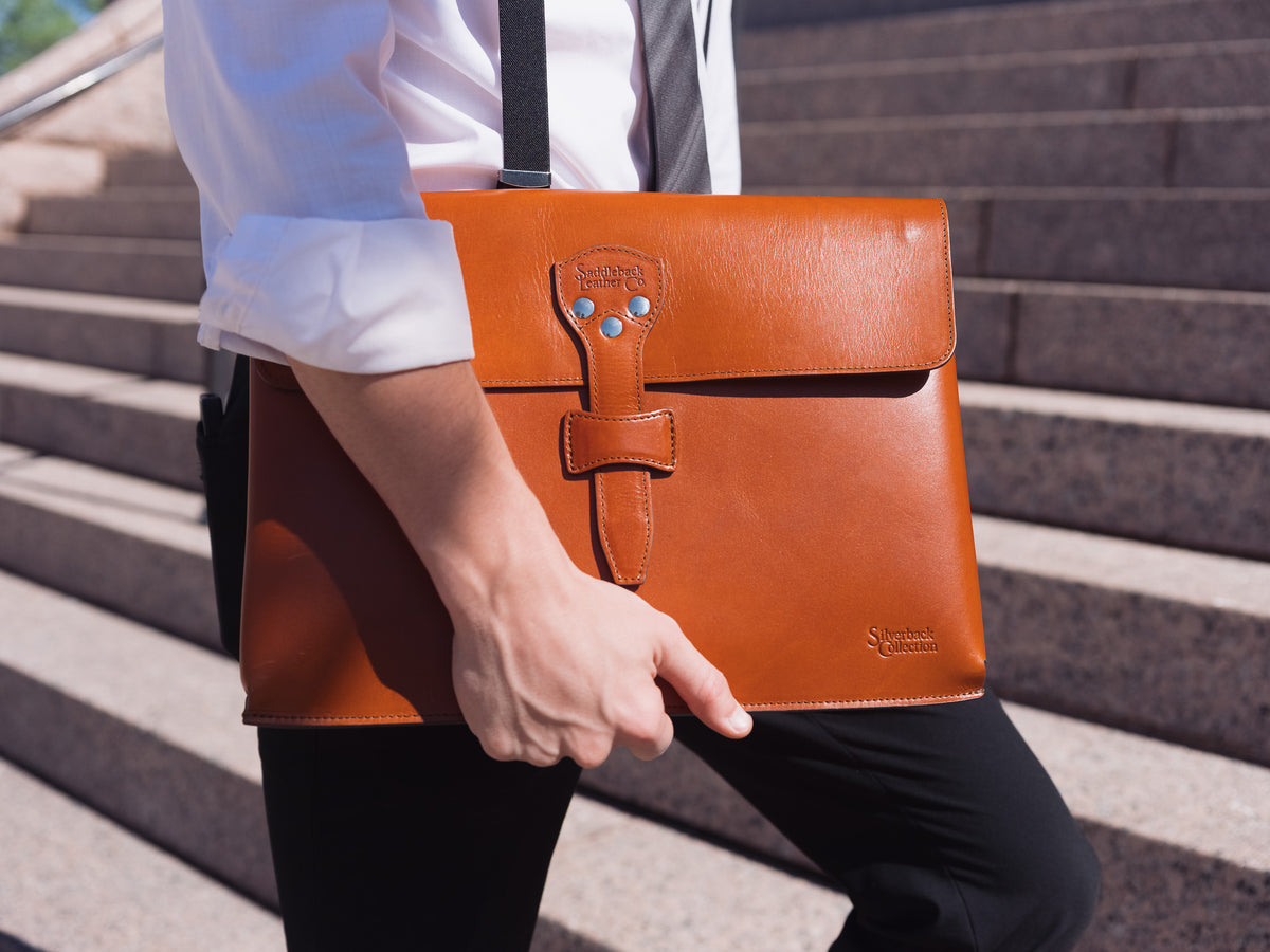 Silverback Document Holder in English Tan, carried under the arm while walking up stone steps
