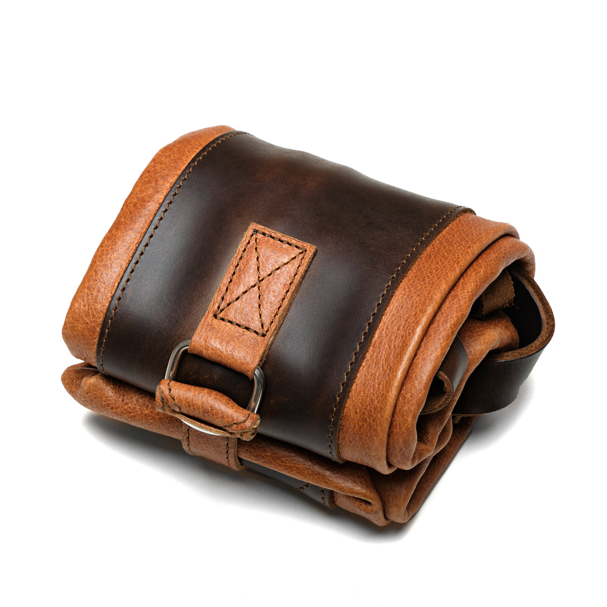 Travel Tote in Bacon, angled close-up rolled up and strapped closed with its leather strap and D-ring