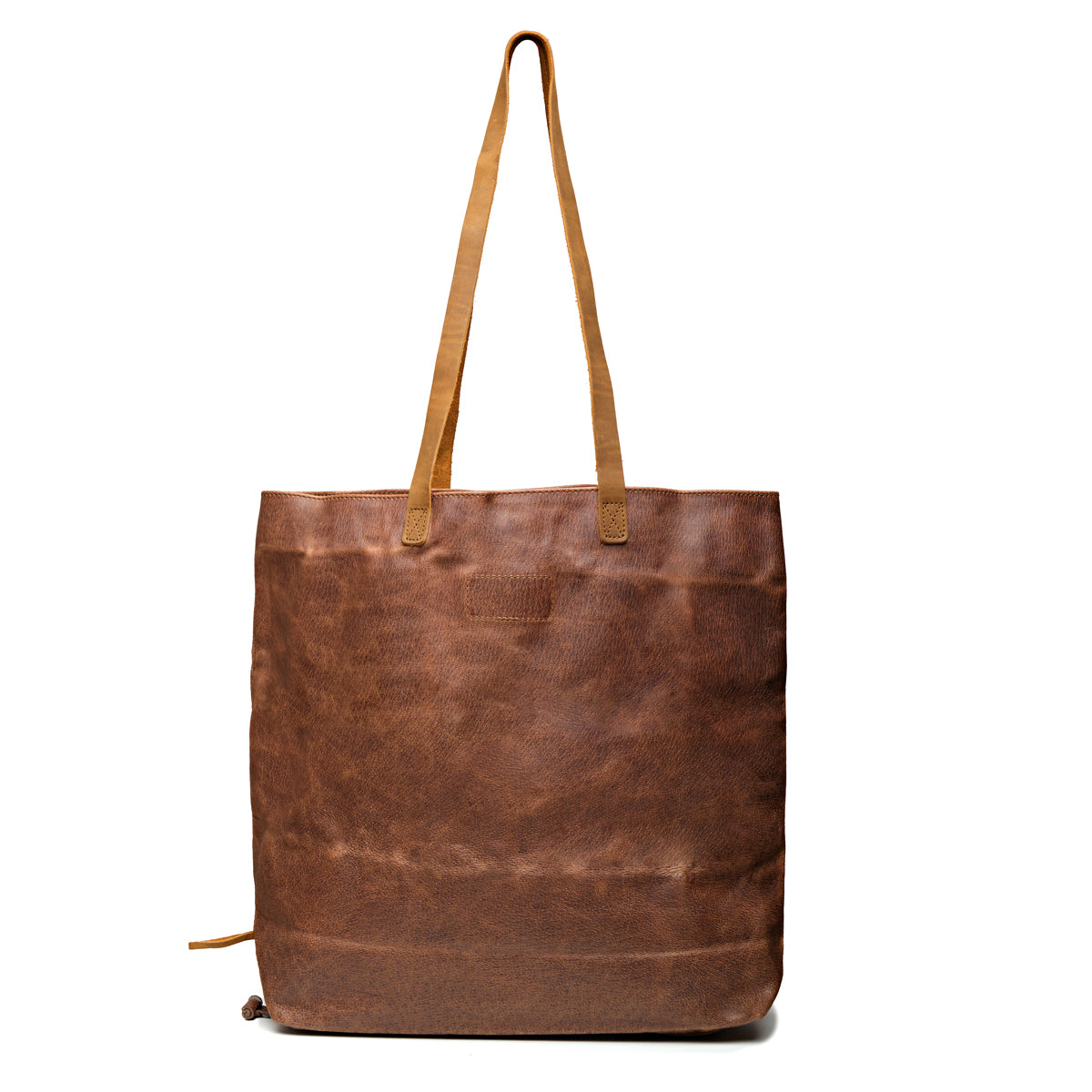 Travel Tote in Burnt Sausage, back view with ridged hogsback leather and two shoulder handles