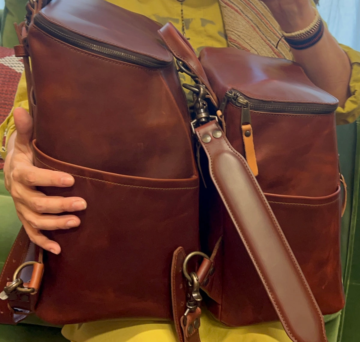 All in One Backpack Medium in Chestnut, two backpacks held side by side showing zippered tops and pockets