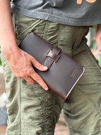 New Big Wallet in Dark Coffee Brown held in hand against olive cargo pants