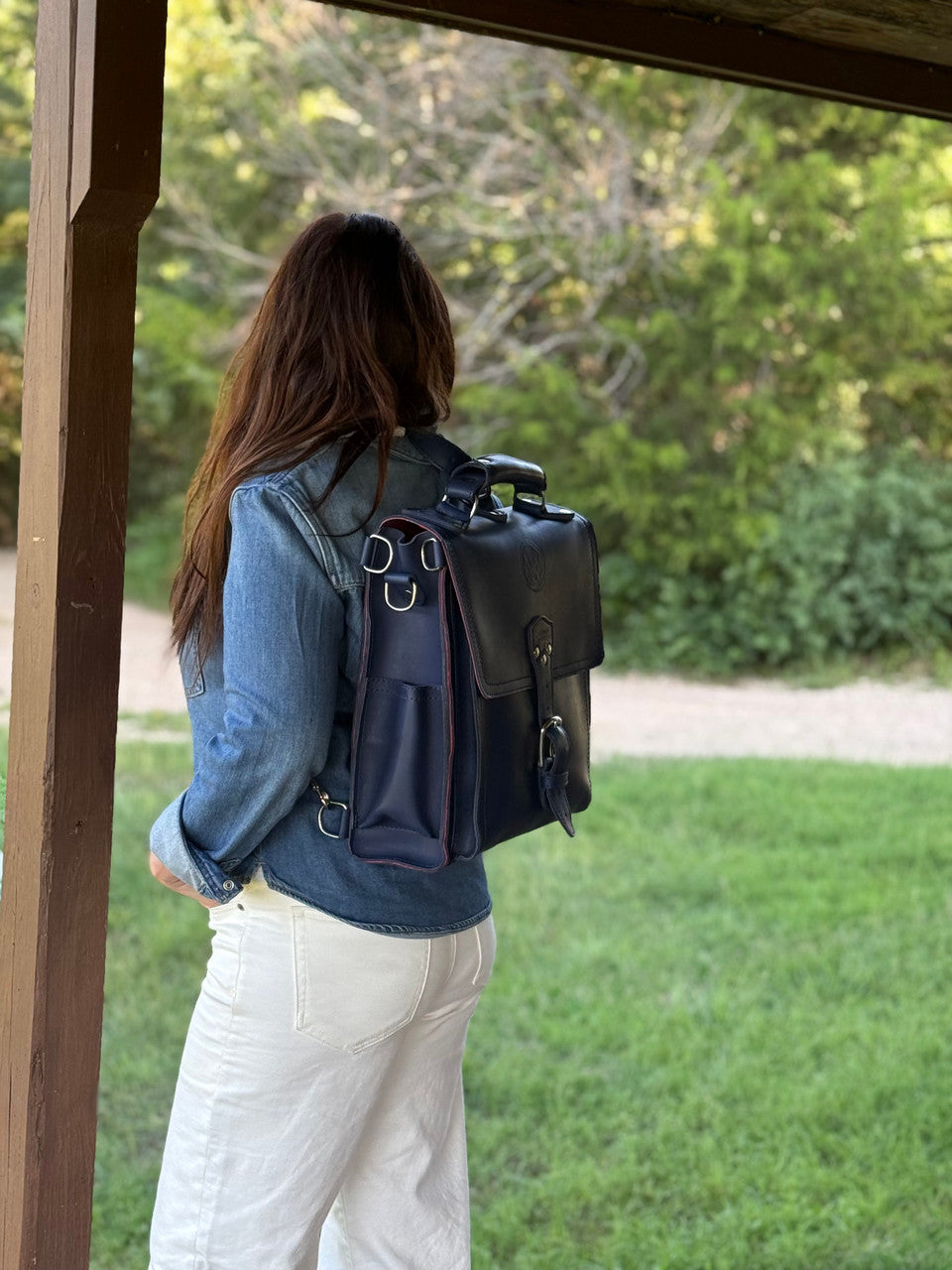 Saddleback Club Membership Paul Revere Leather Messenger Bag Backpack in Red, White and Blue, back view worn on a porch