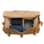 27" Adolescent Beast Duffle Bag in Tobacco, top view open with folded sweaters and black cases packed inside