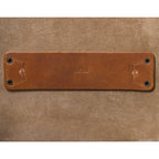 27" Adolescent Beast Duffle Bag in Tobacco, close-up of the stamped leather tab riveted to the suede lining