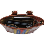 Lanita Leather Backpack in Chestnut, top-down view of unzipped interior holding a laptop and keys