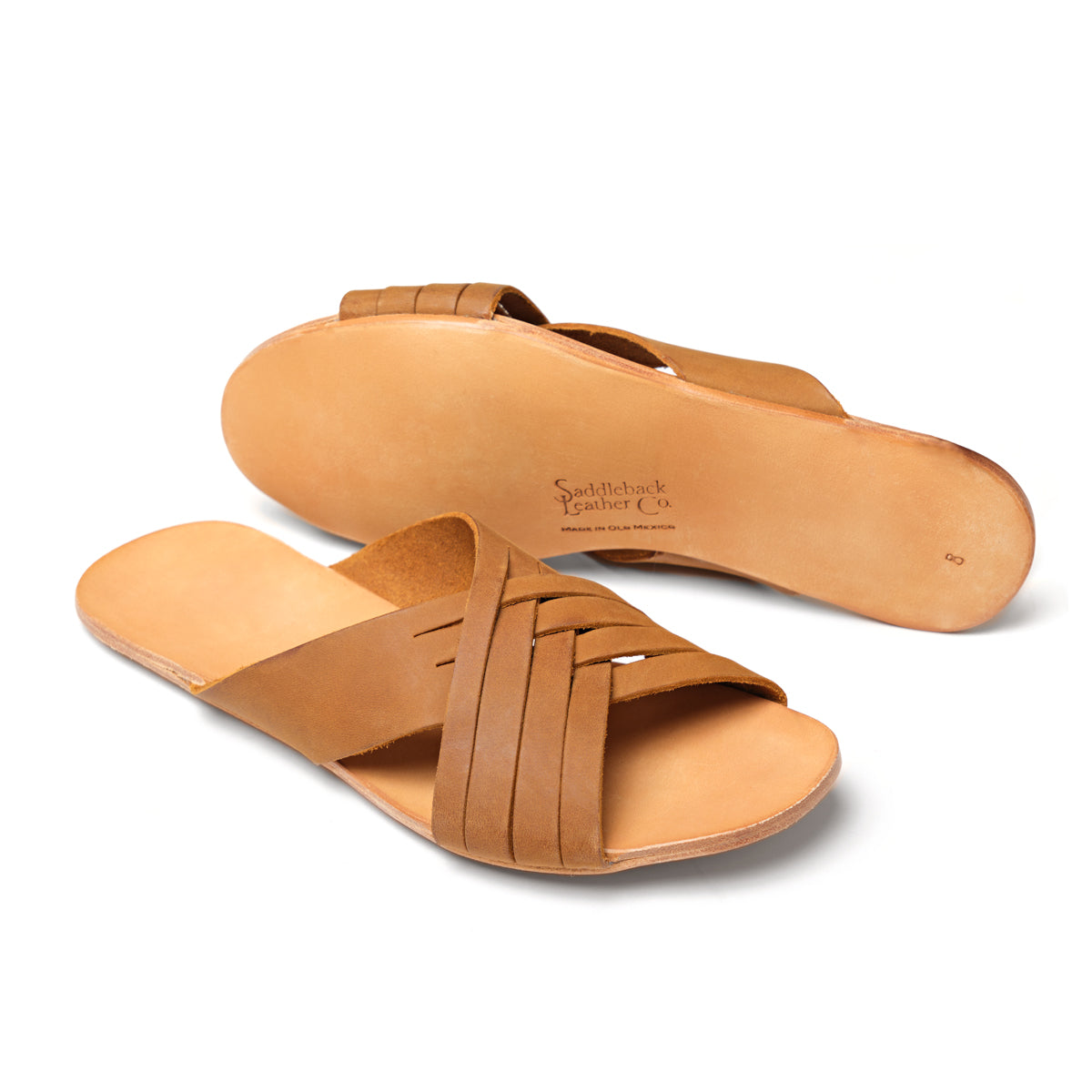 Martha Sandals in Tobacco, one sandal upright and one showing the sole with stamped logo