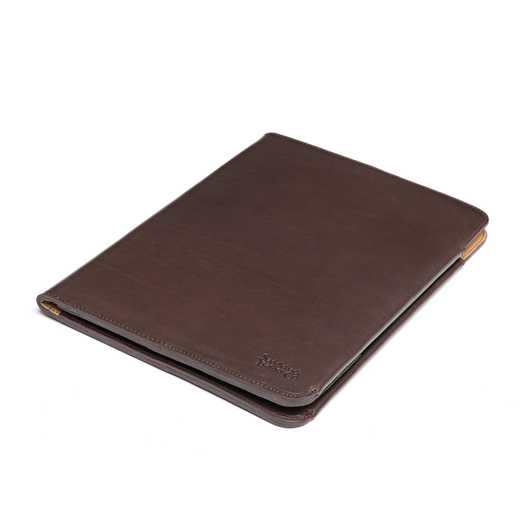New Design Medium Portfolio in Dark Coffee Brown, closed and angled showing the stitched edges and debossed logo